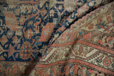 Vintage Malayer runner detail shows navy, blush, and beige henna plant motif with wear.