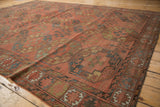 Detail of antique Ersari carpet: brick red, navy, gem green gul motifs, and mostly even wear.