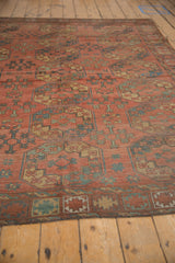 Hand knotted Ersari carpet's geometric gul motifs in brick red, navy, soft green, and sand.