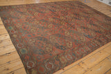 Intricate border design of the antique Ersari carpet with brick red, navy, and pale sand geometric patterns.