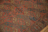 Antique Ersari carpet: repeating geometric gul motifs in brick red, navy, and sand.