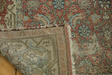 Distressed vintage Hamadan rug corner, featuring worn pile texture, exposed foundation, and fringe.