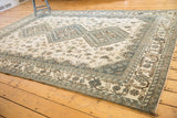 Distressed vintage Shiraz carpet, ivory field with dusty blue tribal patterns and border.