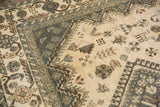 Distressed vintage Persian Shiraz rug, hook-and-latch border, and stylized beige field motifs.