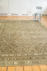 Distressed vintage Shiraz carpet with geometric hook-and-latch motifs and time-softened hues.