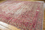 Distressed vintage Meshed carpet: main border cartouche, scrolling floral design, and wear.