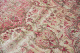 Distressed Meshed carpet with faded raspberry red, pink floral blossoms and scrolling vines.