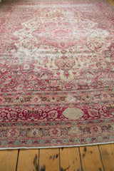 Fringed edge of the distressed Meshed carpet with raspberry red border, cartouche, and visible foundation.