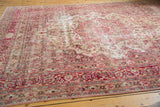 Distressed vintage Meshed carpet borders with raspberry red, pink floral patterns, and wear.