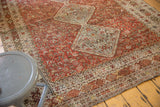 Worn red field and intricate geometric patterns of a distressed vintage Qashqai carpet border.
