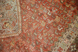 Distressed vintage Qashqai rug segment with tribal animal motifs in chestnut and light blue.