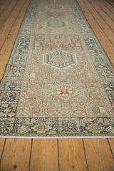 Distressed hand-knotted Karaja runner detail showing geometric vinery in dusty blue, bronze, and ivory.
