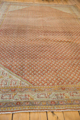 Distressed Sivas carpet corner with intricate borders and burnt orange field.