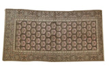 Vintage distressed Khotan rug, charcoal brown field, faded pink floral pattern, distinctive border, 4'8