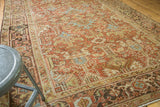 Softened texture and geometric patterns in dusty brick red and powder blue Heriz.
