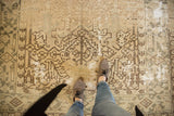 Distressed Heriz rug with primitive geometric design in chocolate brown and soft ivory.