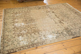 Decorative distressed texture of Heriz carpet with primitive geometric designs in antique ivory and chocolate brown.