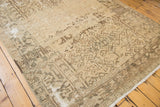 Distressed vintage Heriz border and fringe, revealing primitive geometric motifs and foundation wear.