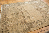 Distressed vintage Heriz carpet detail, primitive geometric patterns on worn pile, foundation visible.