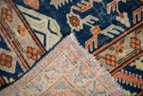 Hand-knotted foundation and mostly even worn navy blue, orange pile of a vintage Khotan carpet.