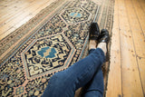 Vintage Hamadan runner's double diamond medallion on aqua blue ground, with intricate navy patterns.