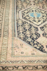 Pale blush main border and intricate navy geometric field of a vintage Hamadan rug.