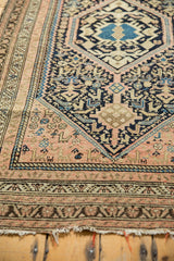 Tattered fringe and detailed geometric border with navy, blush, and sand tones on a vintage Hamadan rug.