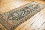 Tattered edge and intricate navy, blush, and sand patterns on a vintage Hamadan runner.