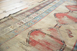 Hard worn pile reveals geometric border details and red design on this antique Caucasian runner.