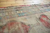 Antique Caucasian runner with visible foundation, low pile, and madder red geometric motifs.