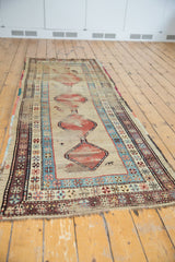 Intricate geometric border design, low pile, and madder red tones on this antique Caucasian runner.