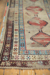Intricate geometric borders, madder red motif, and low pile on an antique Caucasian runner.