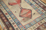 Low pile texture and geometric floral border motifs on an antique Caucasian runner.