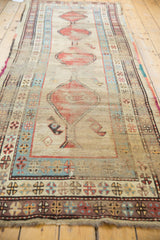 Antique Caucasian runner's low pile, visible foundation, and geometric madder red, powder blue borders.