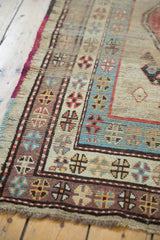 Detail of antique Caucasian runner's geometric borders: ivory, madder red, powder blue, and pale aubergine.