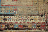 Antique Caucasian border detail: low pile, visible foundation, small hole, geometric motifs, ivory, red, blue.