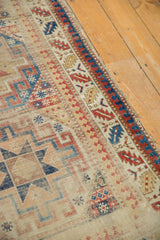 Geometric design motifs, age-worn brick red, sky blue, and beige on an antique Moghan Kazak runner.