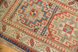 Aged fringe and geometric red, blue, ivory borders of an antique Moghan Kazak runner.