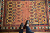 Antique Caucasian rug's geometric guls on unusual gold ground with visible central foundation.