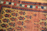 Detail of hand-knotted Antique Caucasian rug showing central foundation wear, gold guls, and madder root red.