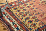 Antique Caucasian rug detail: intricate geometric border, gold ground, repeating guls.