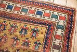 Detailed corner of antique Caucasian rug, featuring geometric guls on gold and complex borders.