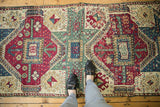 Antique Kurdish hand-knotted runner: geometric multi-medallion pattern in maroon, celadon, ivory.