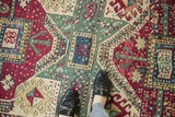 Antique Kurdish rug's geometric multi medallion pattern in maroon, celadon, and antique ivory.