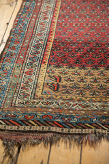 Kurdish Hamadan rug end with gold lattice pattern, diverse borders, and visible tattered fringe.