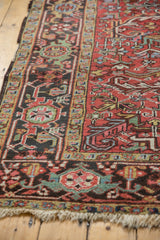 Vintage Mehrivan carpet fringed edge, with cherry red field and detailed chocolate brown border.