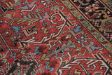Vintage Mehrivan carpet's cherry red field, elongated serrated leaf design, and sky blue accents.