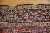 Red, gold, and blue border of vintage Mehrivan carpet showing dramatic serrated leaves.