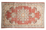 Vintage distressed Oushak rug, brick red and ivory geometric medallion, with mostly even wear.