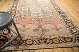 Distressed Oushak rug, meandering vine and floral border with dusty blush field, softened pile.